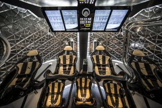This wide shot of Dragon Version 2's interior shows the futuristic display screen and leather-lined seats. Image released May 29, 2014.