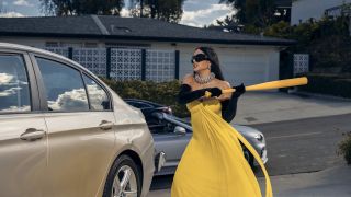 Kim Kardashian's Allura Grant prepares to smash the windows out of a car with a baseball bat in All's Fair.