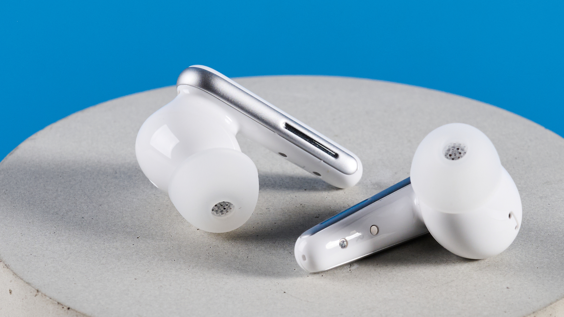 The Soundcore Liberty 5 photographed in front of a blue background.