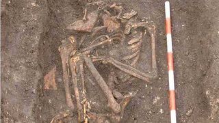 The skeletal remains of a woman buried in a crouched position. 