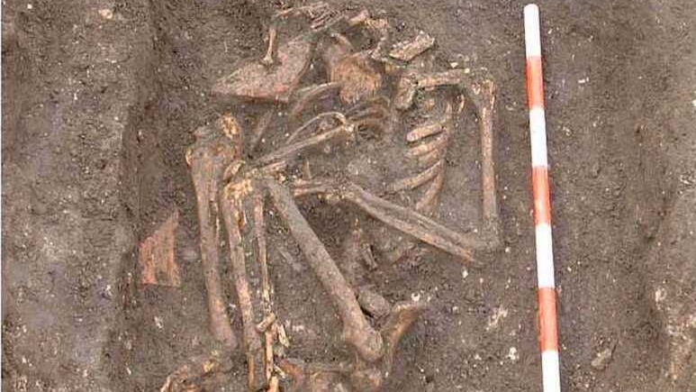 The skeletal remains of a woman buried in a crouched position.
