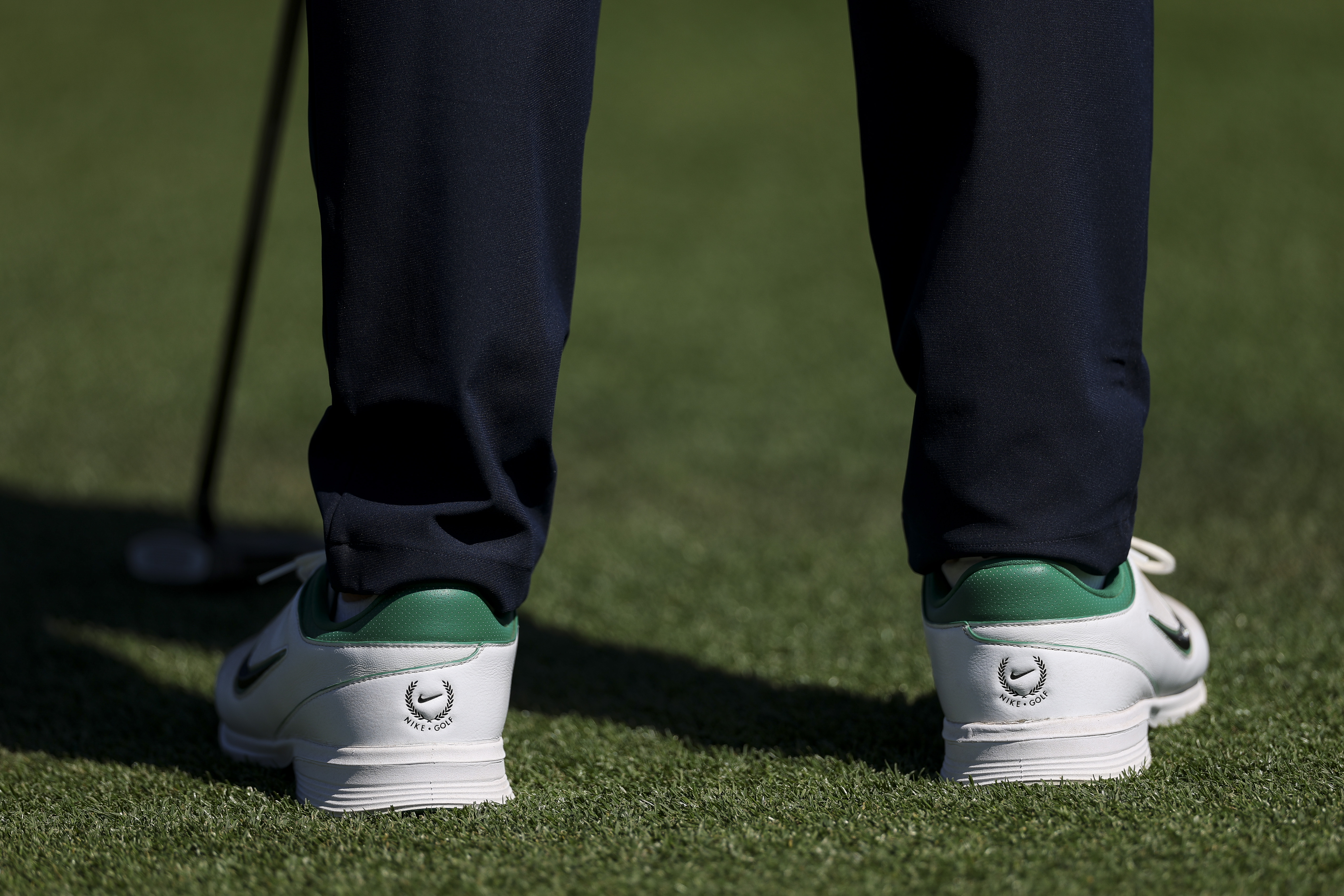 A detailed view of the shoes worn by Rory McIlroy on the 18th green during the first round of the 2026 Masters Tournament at Augusta National Golf Club 