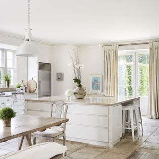 kitchen diner with white walls and white cabinet