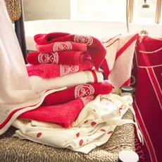 Christy red and white towels on a chair