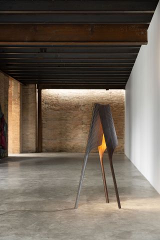 A floor lamp in an industrial space