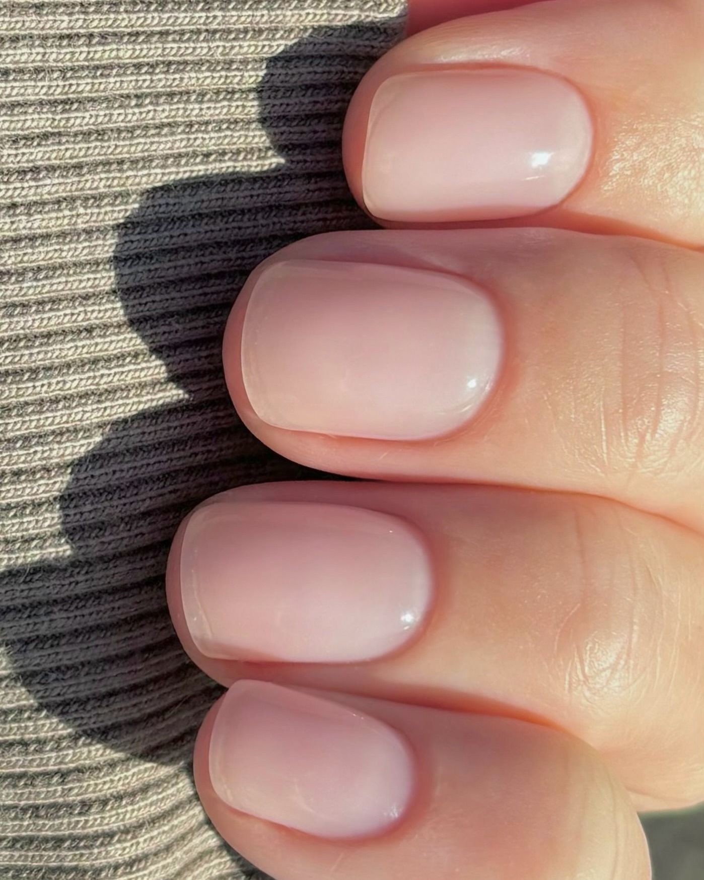 A short, slightly rounded sheer manicure look