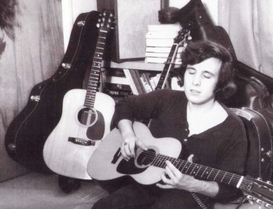 Don McLean, surrounded by other instruments, plays his 1969 Martin 00-21 guitar