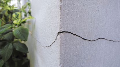 A crack in a white plaster wall