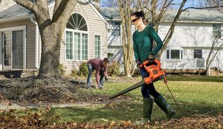 Woman using BLACK+DECKER Electric Leaf Blower, Leaf Vacuum and Mulcher