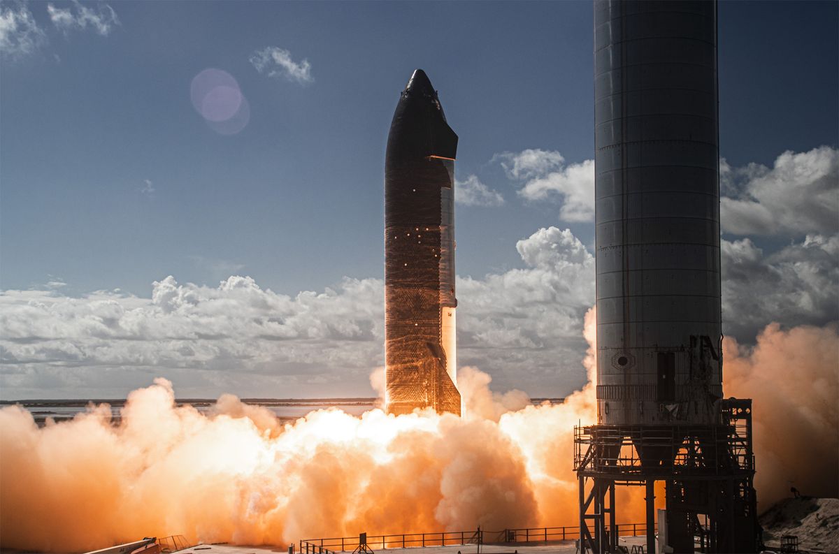 This SpaceX photo shows the first test-fire of six Raptor engines on the company&#039;s Starship SN20 rocket prototype on Nov. 12, 2021 at the Starbase facility in near Boca Chica Village in South Texas. A Starship Super Heavy booster stands at right.