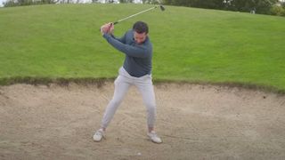 Photo of Joe Ferguson digging it out of a plugged lie in the bunker