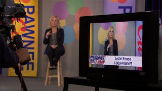 Leslie Knope (Amy Poehler) hosting a telethon in Parks and Recreation