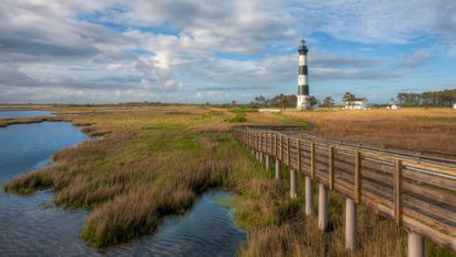 The Bodie Island lighthouse and adjacent boardwalk in Cape Hatteras National Seashore in the Outer Banks of North Carolina