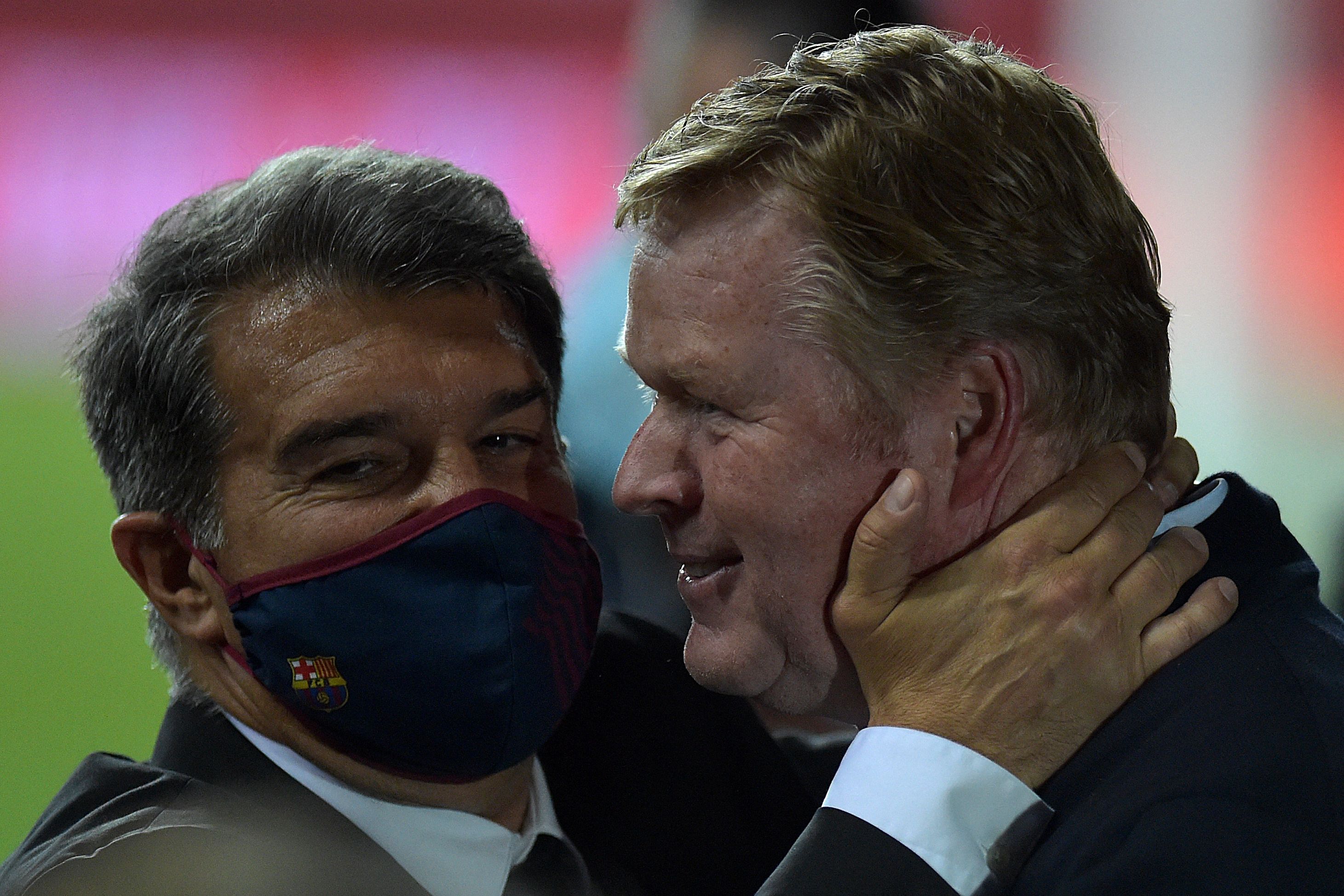 Ronald Koeman (right) is congratulated by Barcelona president Joan Laporta after the team's Copa del Rey final win over Athletic Club in April 2021.