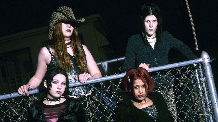 Kittie posing over a chainlink fence in 2001