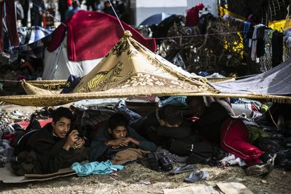 Migrants camp out under makeshift tents in Tijuana.