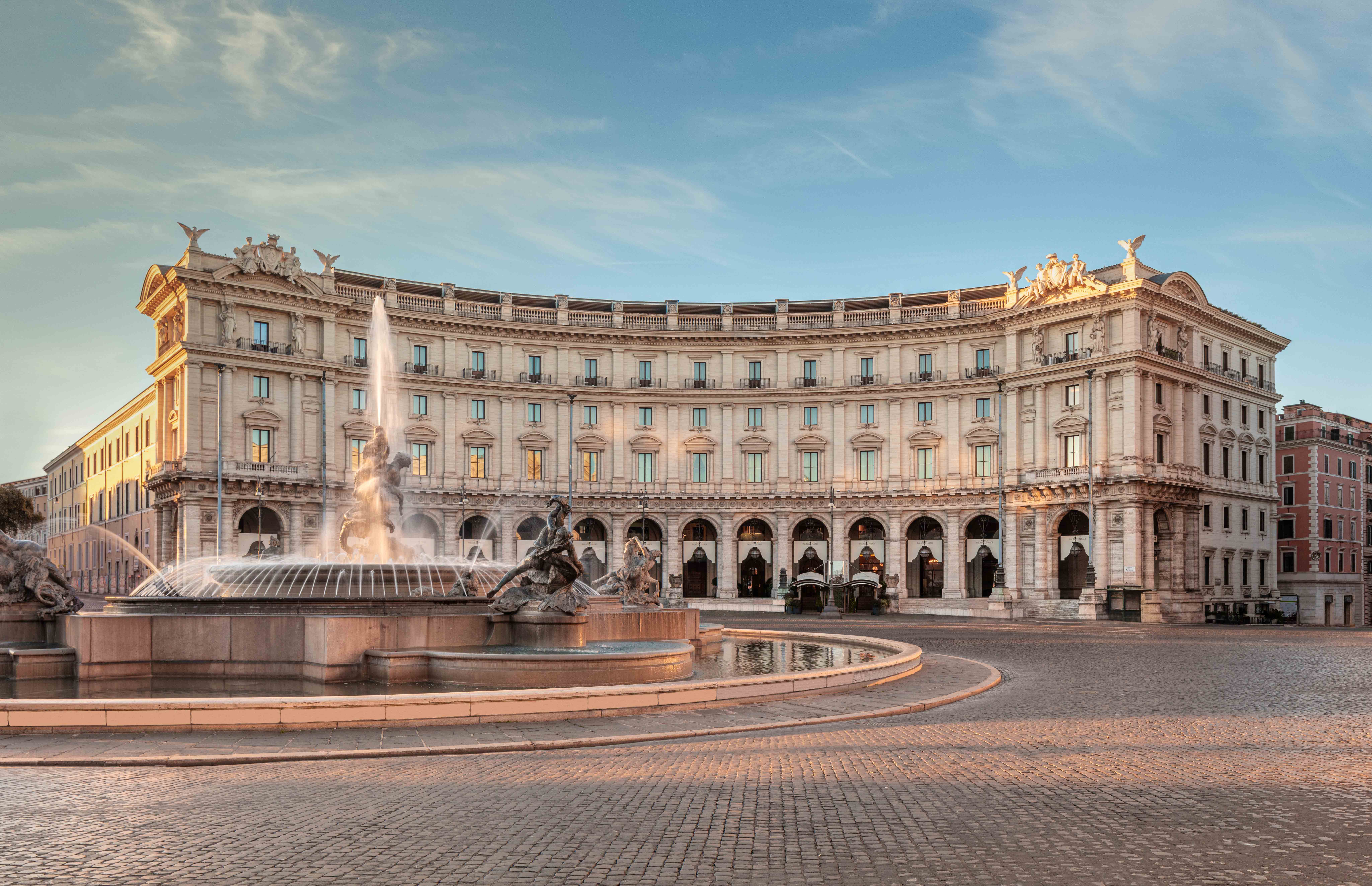 Anantara Palazzo Naiadi overlooks Rome&amp;rsquo;s Piazza della Repubblica, with its grand curved fa&amp;ccedil;ade facing the Fountain of the Naiads in the soft light of early morning.