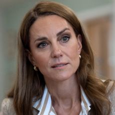 Kate Middleton wearing a striped tan shirt and blazer 