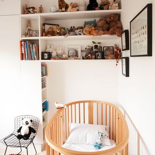 kid room with shelves on wall and teddy bear