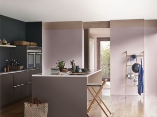 lilac and pink kitchen with navy wall, kitchen island, breakfast bar and bar stool, wooden floor