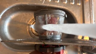 how to remove a dishwasher filter - the internal filter being cleaned in writers sink side view