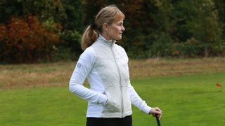 A golfer wears the Galvin Green Darlena Insulating Mid Layer