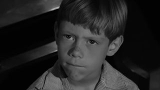 A boy looking angry in the twilight zone episode It's A Good Life