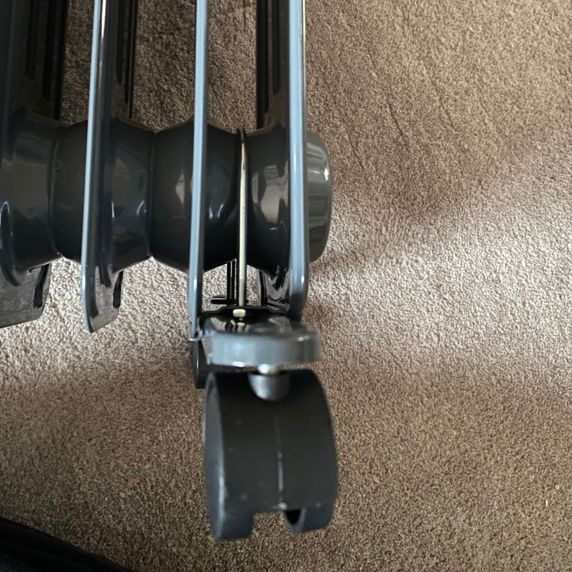 Close up of the wheels of the Morphy Richards HeatFlux 2.5kW Digital Oil-filled Radiator attached to the fitted u-bolt