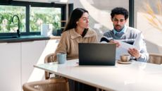 Stressed young couple going through their household finances using a laptop