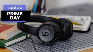 Beats Solo 3 wireless headphones on a desk with books