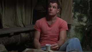 A man in a red shirt in a scene from Midnight Express