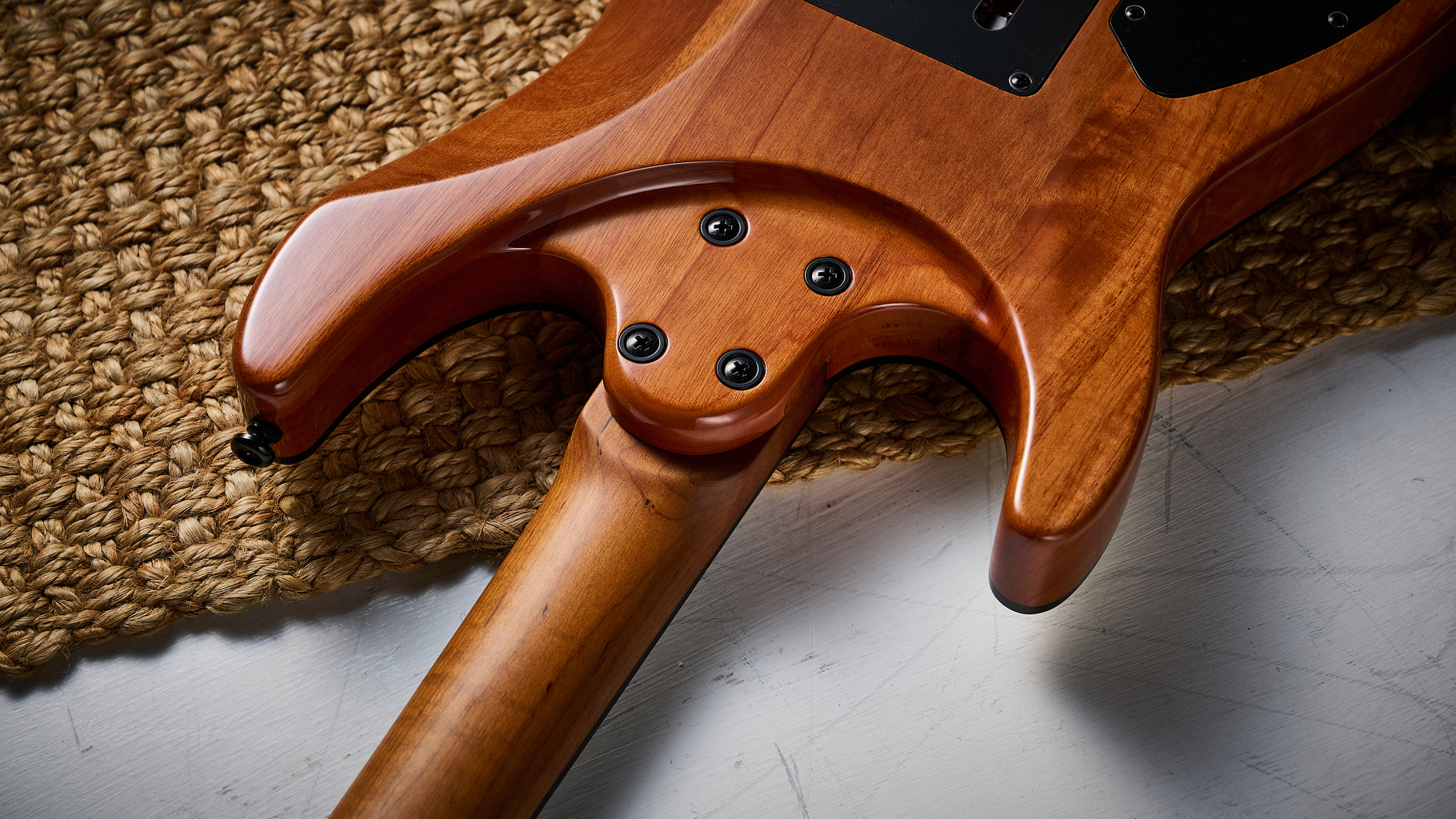 The sculpted neck heel of a Harley Benton Fusion IV HH electric guitar
