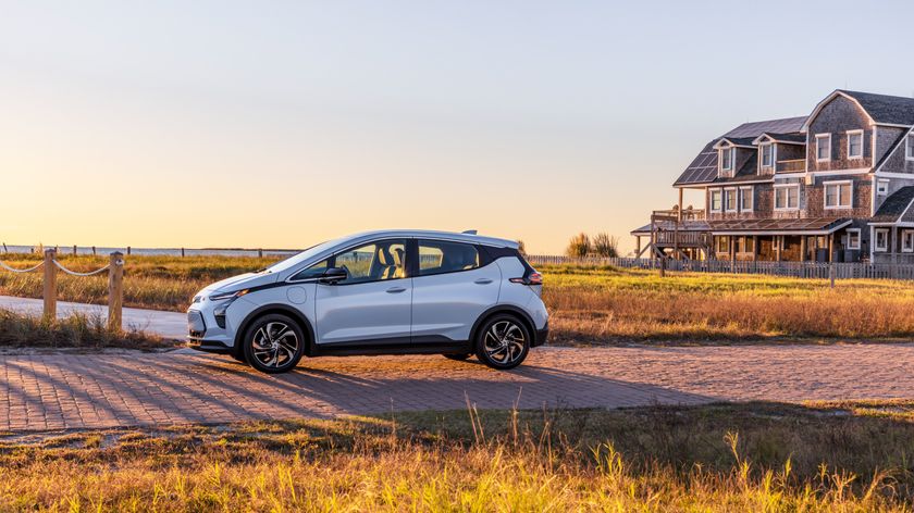 The Chevrolet Bolt parked on a track through a farm