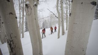 Three people hiking in the snow in Utah