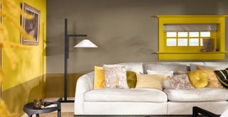 Living room with brown wall behind the sofa and Dulux colour of the year 2025 yellow on the side walls