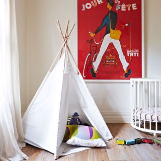 kids room with white tent and wooden flooring