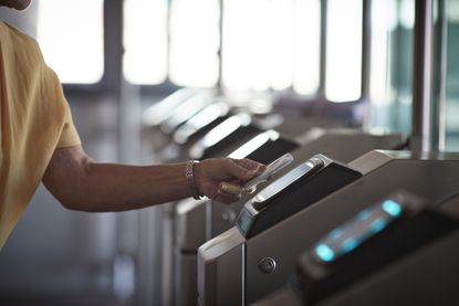 Woman going through train station barrier