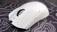 A photo of a white Razer Viper V4 Pro wireless gaming mouse on a colorful mouse pad