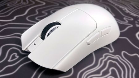 A photo of a white Razer Viper V4 Pro wireless gaming mouse on a colorful mouse pad