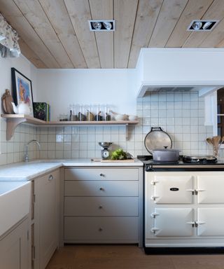 white kitchen in Swiss chalet by Sims Hilditch