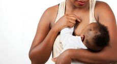 A woman breast-feeding a baby.
