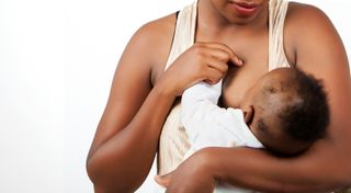 A woman breast-feeding a baby.