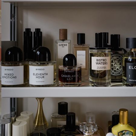 A shelf with perfume bottles on top
