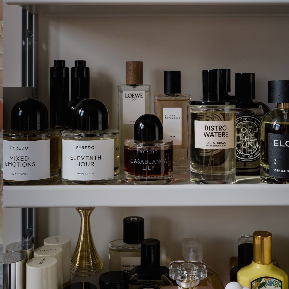 A shelf with perfume bottles on top