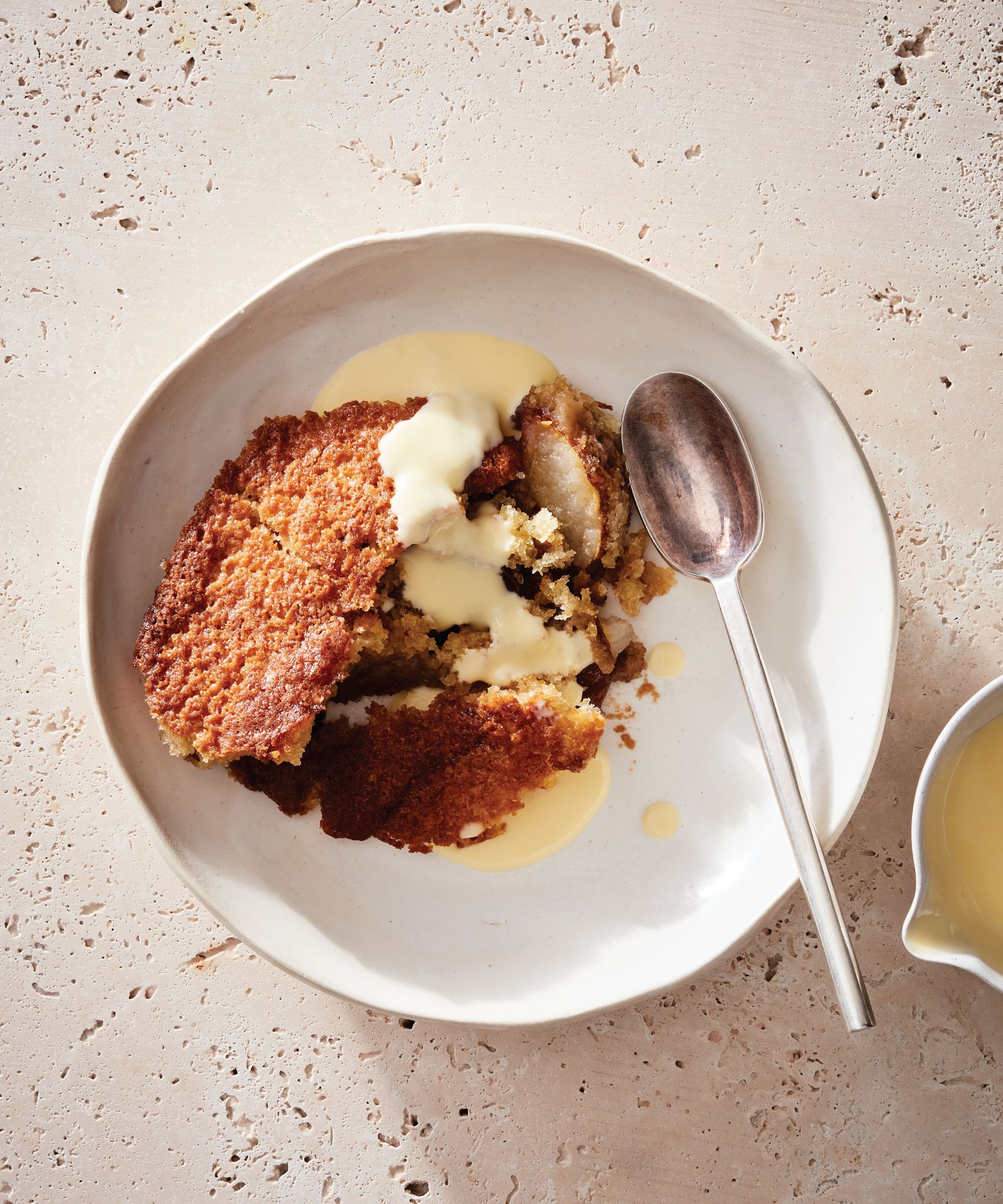 Caramel pear cobbler in a bowl with creme anglaise