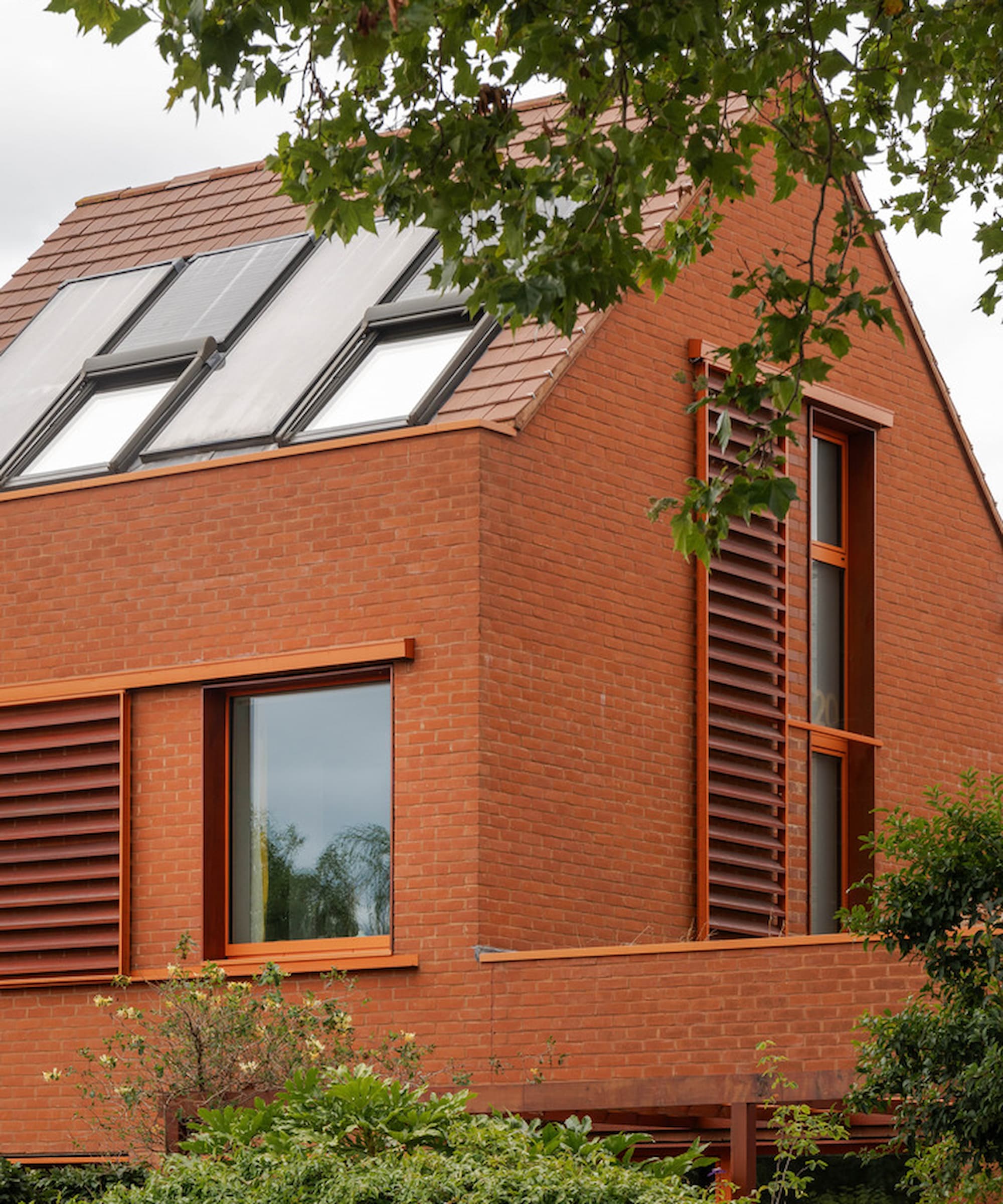 A brick Passivhaus with ventilation shafts running up the side of the house