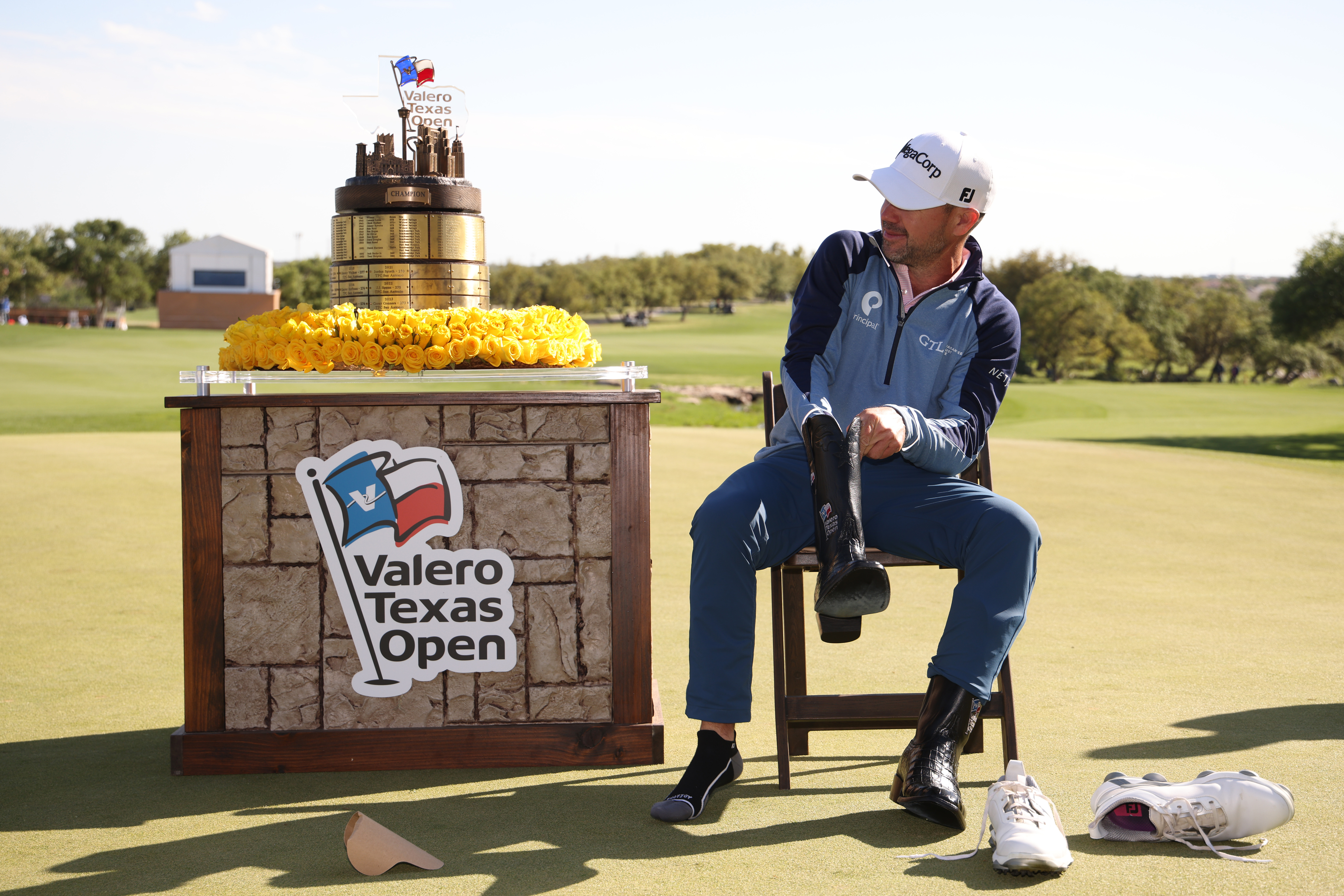 SAN ANTONIO, TEXAS - APRIL 06: Brian Harman of the United States putts on cowboy boots on the 18th green after winning the final round of the Valero Texas Open 2025 at TPC San Antonio on April 06, 2025 in San Antonio, Texas. (Photo by Mike Mulholland/Getty Images)