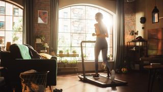 A woman running on a treadmill at home