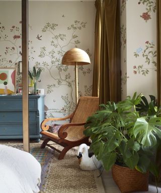 eclectic layered bedroom with floral wallpaper and vintage furnishings