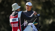 Norman Xiong speaks to his caddie during PGA Tour Q-School
